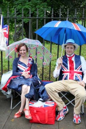 Unperturbed ... revellers queue to enter a Jubilee Party in the rain.