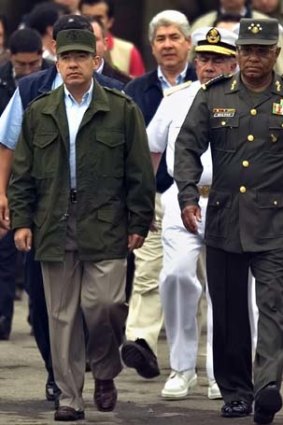 In this 2007 photo, Mexico's President Felipe Calderon, left, walks with his Secretary of Defense Guillermo Galvan.
