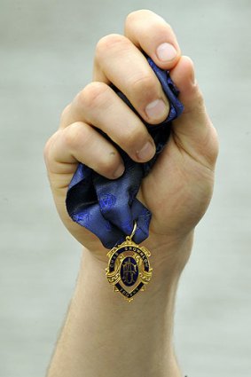 A Brownlow Medal in Gary Ablett’s hand.