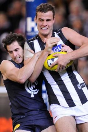Carlton's Andrew McInnes tackles Collingwood's Jarrod Witts in Round 15, 2013.