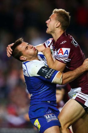 One on one: Josh Reynolds of the Bulldogs collides with Daly Cherry-Evans of the Sea Eagles at Brookvale Oval on Friday.