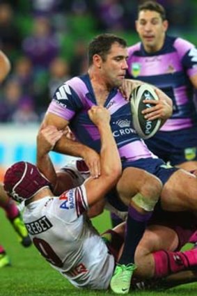 Storm skipper Cameron Smith is tackled by Matt Ballin of the Sea Eagles during Monday night's match.