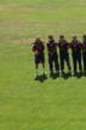 Eastlake and Weston Creek players observe a minute's silence for Ron Oakes.