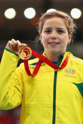 Elkington shows off her gold medal.