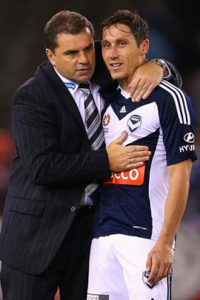 Relief: Victory coach Ange Postecoglou with Mark Milligan.