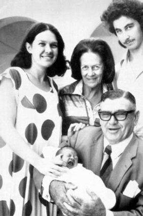 Dynasty … Lang, holding his newborn grandson, John, with Gina, Lang’s wife, Hope, and Gina’s husband, Greg, in Perth in 1976.