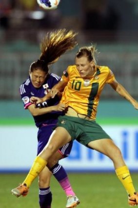 Emily van Egmond of Australia battles with Sawa Homare of Japan.