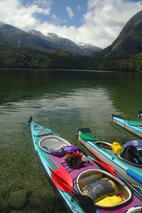 Kayaks on remote beach in Doubtful Sound.