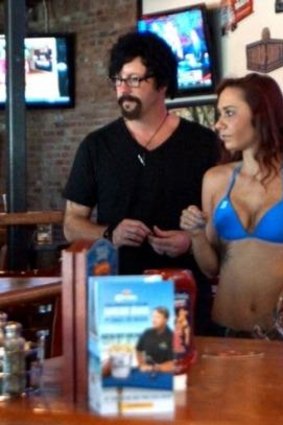 Bikinis CEO Doug Guller and his employee Grace, who was awarded with bigger breasts.