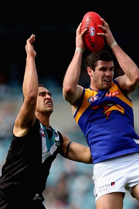 Jack Darling of the Eagles marks over Alipate Carlile of the Power.