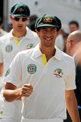 Ashton Agar smiles as he walks out during day four of the first Test.