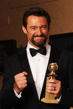 Glittering stars ... Hugh Jackman poses in the press room during the 70th Annual Golden Globe Awards.