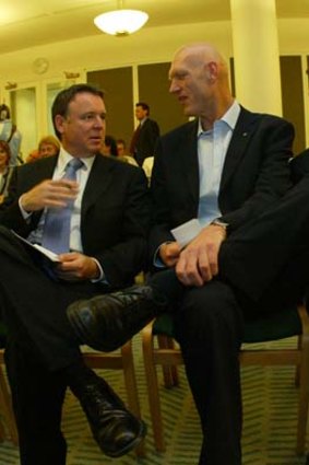 Joel Fitzgibbon (left) and Chris Bowen seated on either side of Peter Garrett during an ALP caucus meeting in 2004.