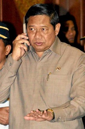 Indonesian President Susilo Bambang Yudhoyono speaks on his mobile phone.