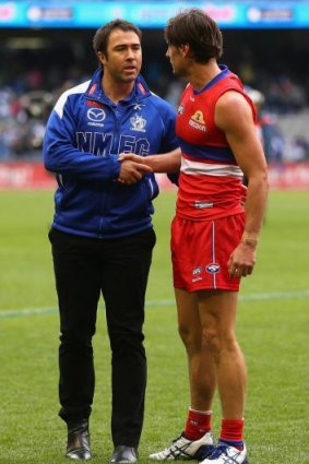 Brad Scott congratulates Ryan Griffen of the Bulldogs who played his 200th game on Sunday.