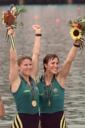 Australia's Gold medalists Megan Still (L) and Kate Slatter (R) in the women coxless pairs celebrate during the medals ceremony, July 27.  USA won the Silver and France the Bronze in the event.