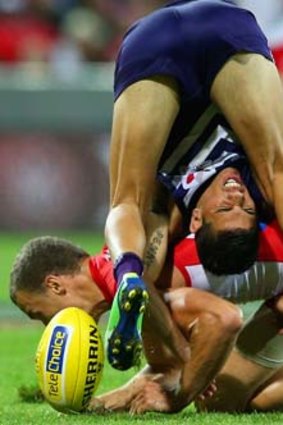 Head down: Sydney's Ted Richards upends Fremantle's Michael Walters.
