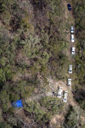 Crime scene ... police at the spot off the fire trails near Brethren Point Road where the human remains were found.