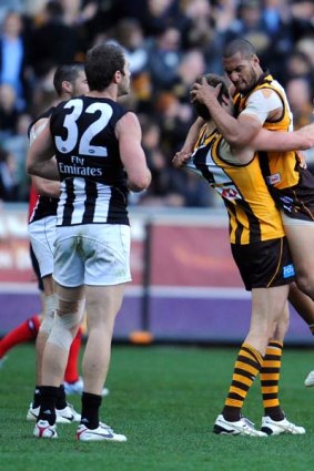 Stephen Gilham and Josh Gibson celebrate Hawthorn's win over Collingwood.
