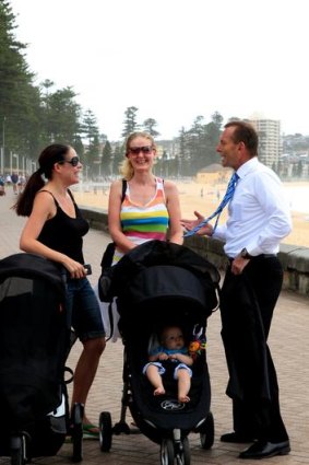 Abbott chats with Manly locals Meg Garrido and Zoe Whitcomb.