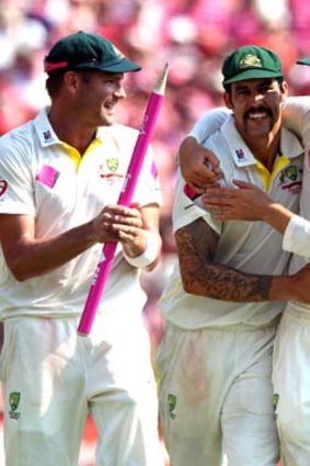 Harris, Johnson and Nathan Lyon celebrate after wrapping up the series 5-0 at the SCG on Sunday.
