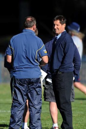 Wallabies coach Robbie Deans, right, chats with Brumbies coach Jake White at Brumbies training on Tuesday.