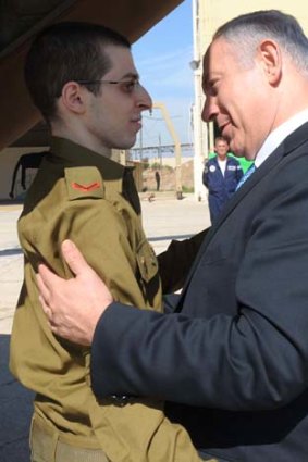 Gilad Shalit is welcomed by Israeli Prime Minister Benjamin Netanyahu at the Tel Nof airbase.
