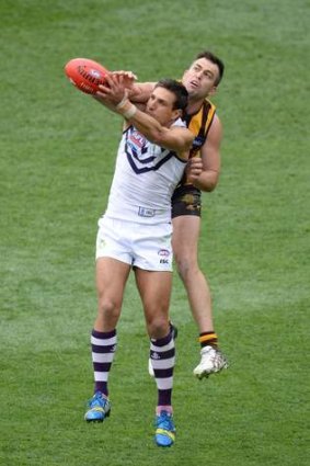 Matthew Pavlich marks in front of Brian Lake.