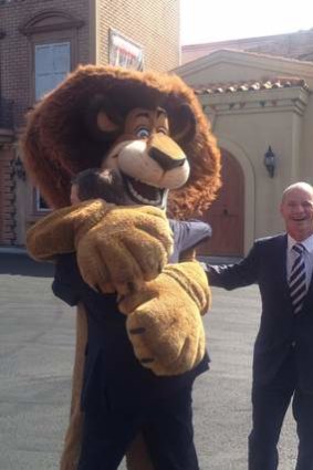 Alex the lion gives Treasurer Tim Nicholls a hug, but Premier Campbell Newman misses out, at Movie World.