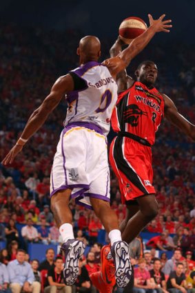 Charles Carmouche of the Kings look to block James Ennis of the Wildcats during the round two NBL match between the Perth Wildcats and the Sydney Kings at Perth Arena.