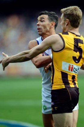 Ryan Crowley confronts Hawthorn's Sam Mitchell during the 2013 grand final.