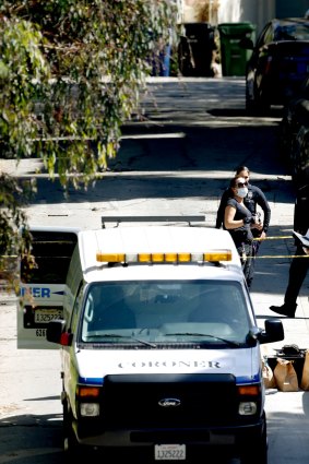 Investigators stand by the Los Angeles County coroners van after the body of a man was moved into it from a home in the Hollywood Hills section of Los Angeles, Friday, Sept. 23, 2016. Police were called Friday to the neighborhood not far from the Hollywood Bowl.