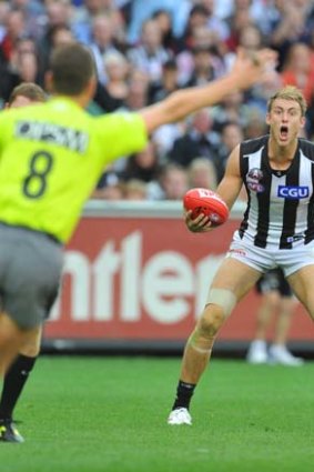 Collingwood's Ben Reid was too strong for Tom Bellchambers in a marking contest... and had a free kick paid against him for a push in the side.