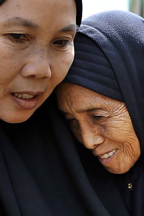 Tariyem  (right) the mother of Bali Bombers Amrozi and Muklas is supported by family members in their home villiage of Tenggulun where they are expected to be buried on Monday.