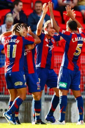 Happy days: The Jets celebrate Brockie's opening goal.