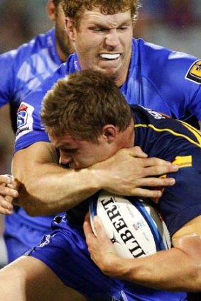 Michael Hooper is tackled by David Pocock.