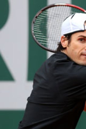 Tommy Haas of Germany plays a backhand in his Men's Singles match against Jack Sock of United States of America during day six of the French Open at Roland Garros on May 31, 2013 in Paris, France.