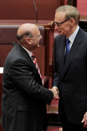 Senator Bob Carr is congratulated by NSW Liberal Senator Arthur Sinodinos after he was sworn in as a NSW senator.