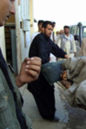 A victim of the airstrike on an oil tanker hijacked by Taliban insurgents is carried into the main hospital in Kundu.