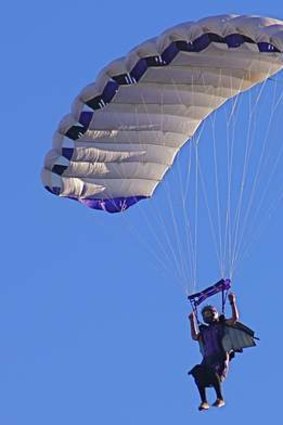 Kirsten Moriarty flying her parachute, wearing her wingsuit.