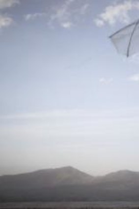 Body of work: An Afghan boy flies his kite on a hill overlooking Kabul, Afghanistan.