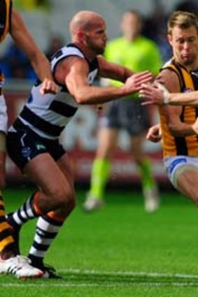 Hawthorn's Sam Mitchell finds himself surrounded by Geelong's Paul Chapman, James Kelly and Joel Selwood when the teams met in round 2 this year.