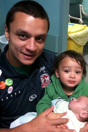 His most important job .. Roosters star Sam Perrett with Sam jnr.
