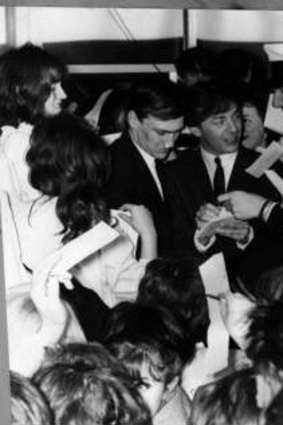 Gerry Marsden, centre, lead singer of the British group Gerry and the Pacemakers, is surrounded by fans during a personal appearance at the Southern Cross Hotel, Melbourne, to aid the Miss Teenage Quest and the Royal Hospital.