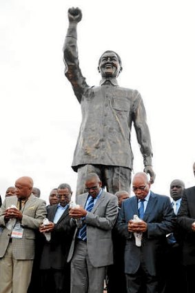 A giant statue of former president Nelson Mandela unveiled  in Bloemfontein, South Africa, by president Jacob Zuma (second from right).