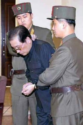Jang Song-Thaek being escorted in court on December 12, 2013 before being executed.