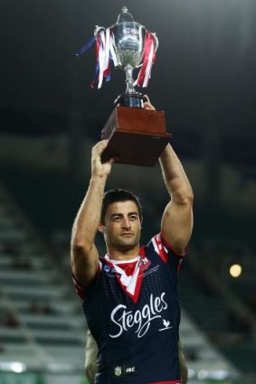 Proud moment: Anthony Minichiello holds aloft the World Club Challange trophy after the win over Wigan in February.