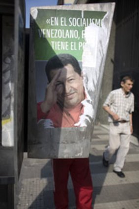 Hanging on ... a Chavez  poster covers a phone booth as voters prepare for election day.