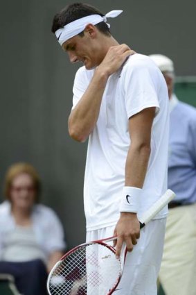 Bernard Tomic reacts during his first-round defeat to Belgian David Goffin.