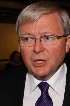 In his hands: Former Prime Minister Kevin Rudd.